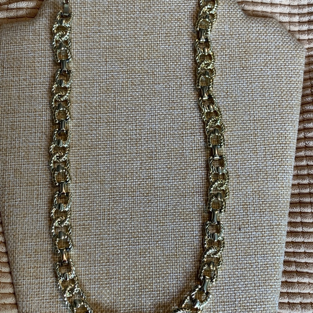 Long vintage gold tone necklace. Unique stirrup type design.